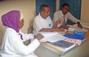 Dr Djibril I. Moussa Handuleh (centre) and colleagues discussing cases at a mental health clinic in Borama, Somalia.