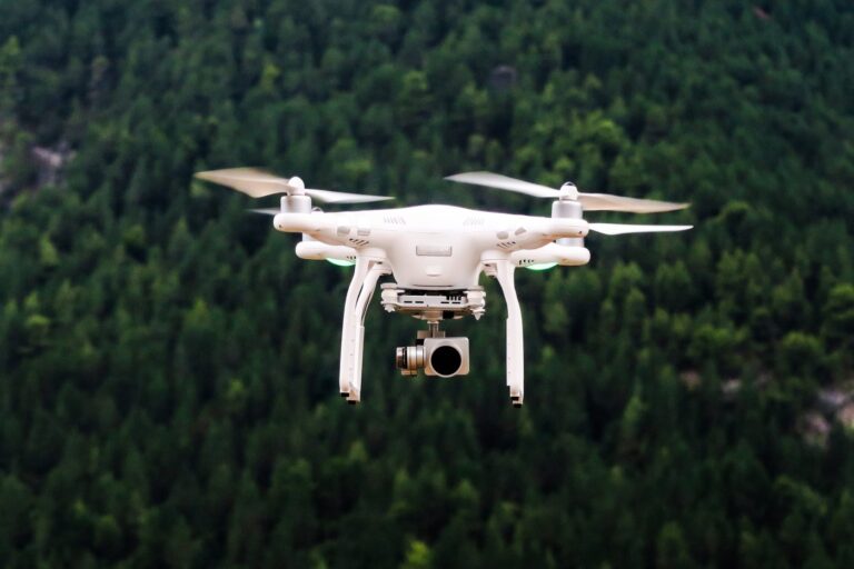 photo of small drone with camera flying