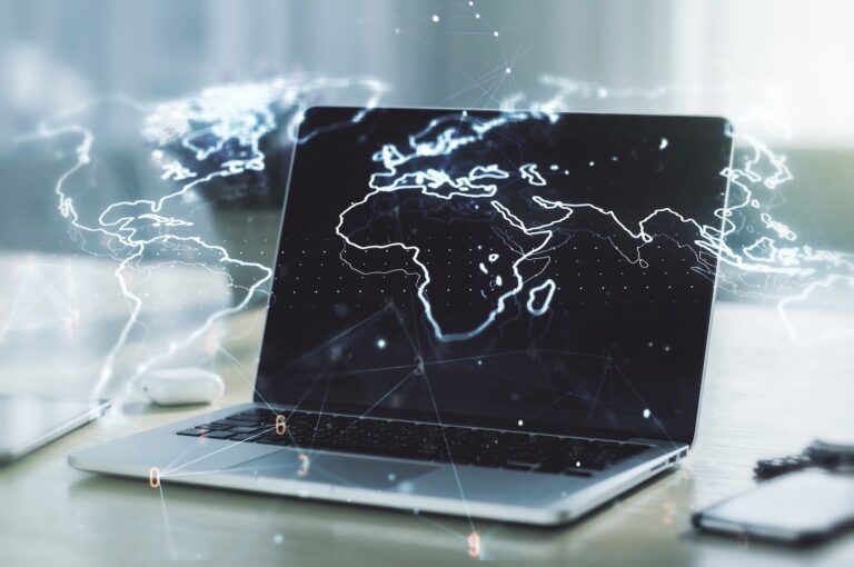 Laptop surrounded by 3D map of the world