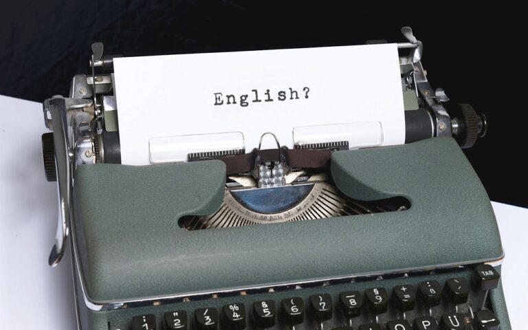 vintage typewriter holding paper showing the word English?