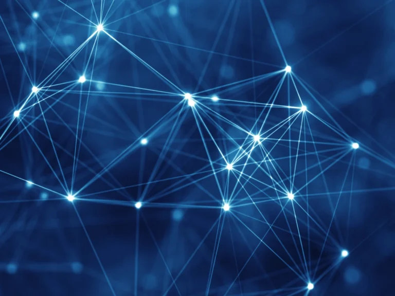 Glowing white nodes connected by lines against a deep blue background, forming an abstract network.