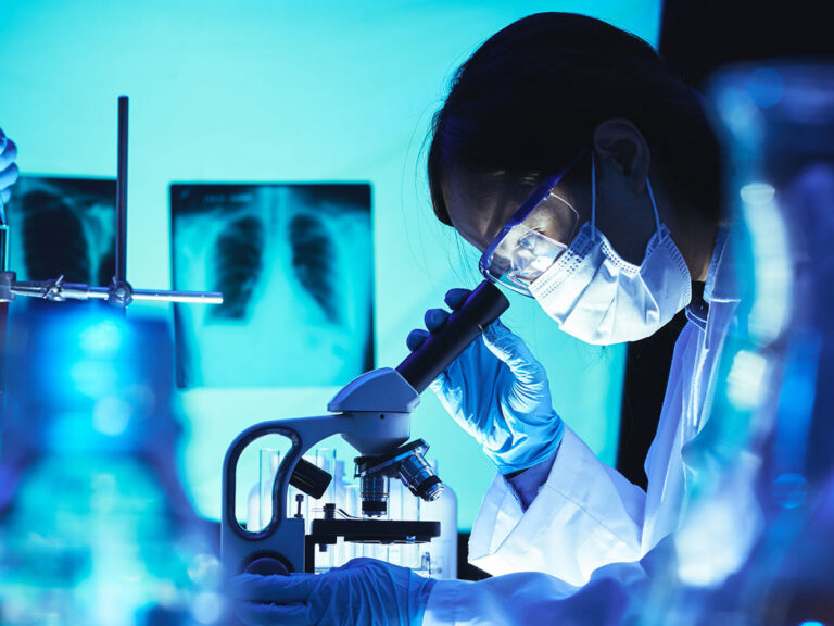 researcher using microscope