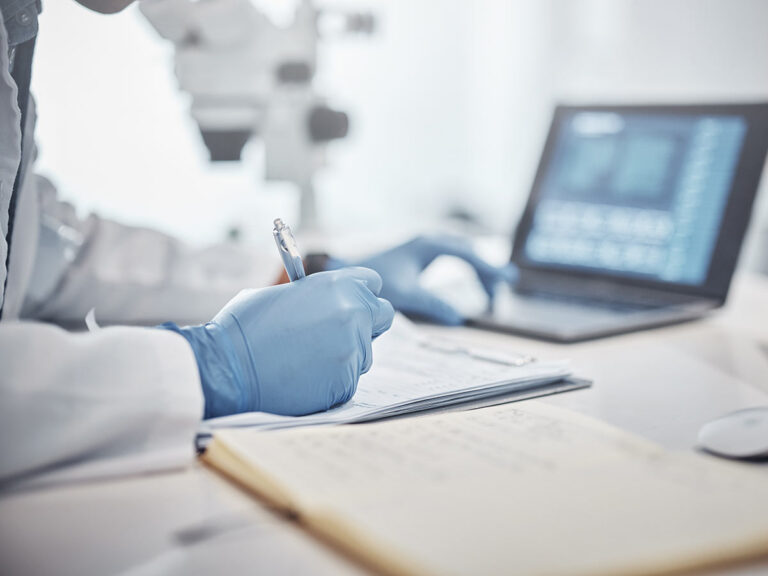 medical researcher working with laptop